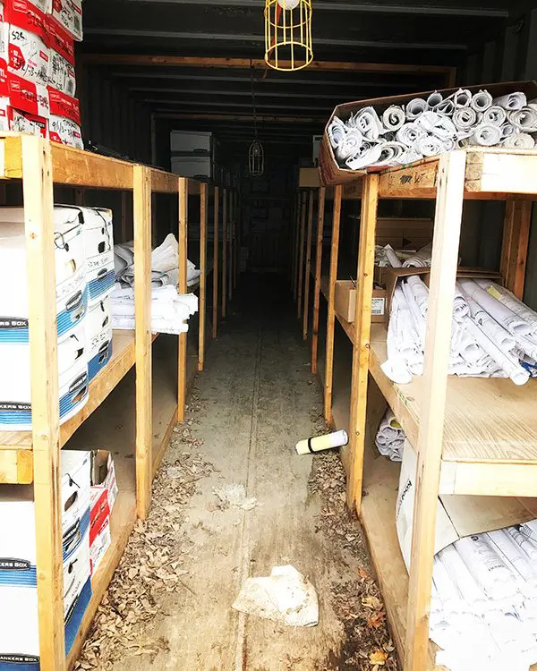 The inside of a shipping container full of rolled paper boxed documents to be shred
