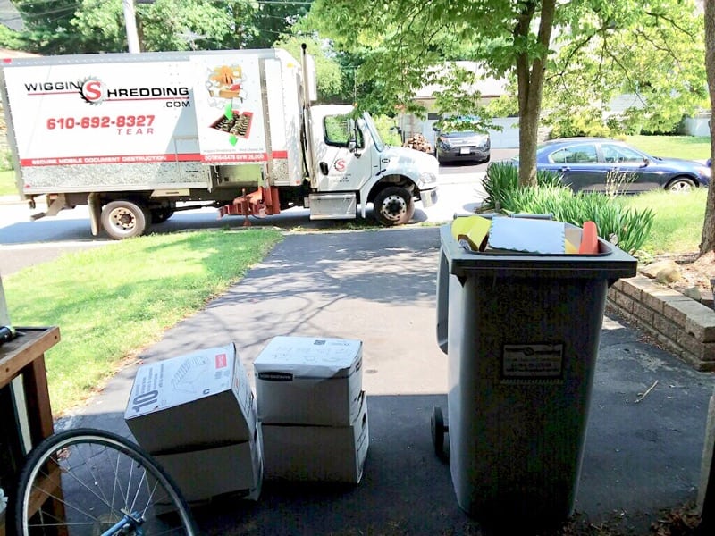 Wiggins Shredding Truck outside a home with boxes of materials to be shred.