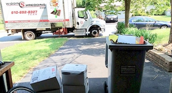 Wiggins Shredding Truck outside a home with boxes of materials to be shred.
