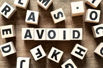 Wooden Blocks with letters spelling the word AVOID.