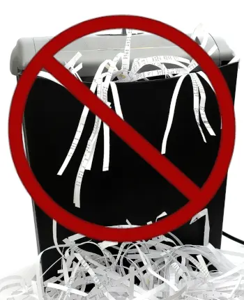 Portable office shredder isolated on a white background with "do not" symbol (red circle with line through it) over the shredder.