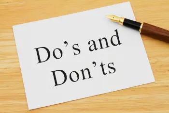 A white card on a desk with a pen with words Do's and Don'ts