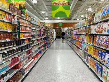 Long view down the cereal, coffee and tea aisle at a grocery store