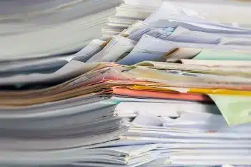 Closeup photo of a stack of multi-colored booklets and documents.